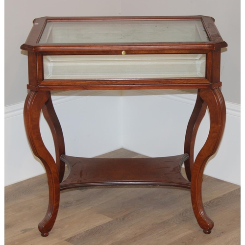 133 - An antique style mahogany bijouterie table with bevelled glass panels and cabriole shaped legs. appr... 