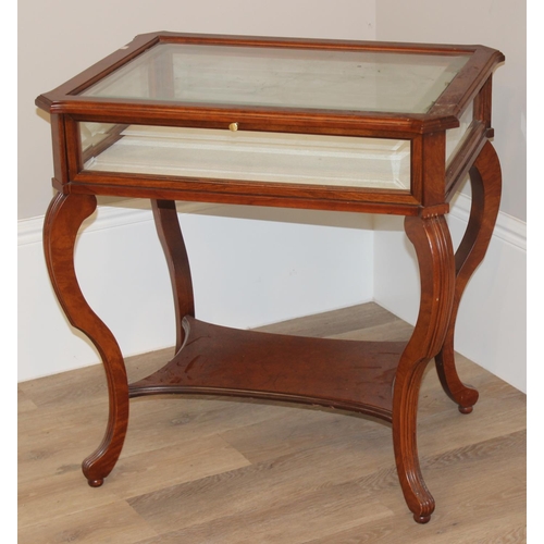 133 - An antique style mahogany bijouterie table with bevelled glass panels and cabriole shaped legs. appr... 