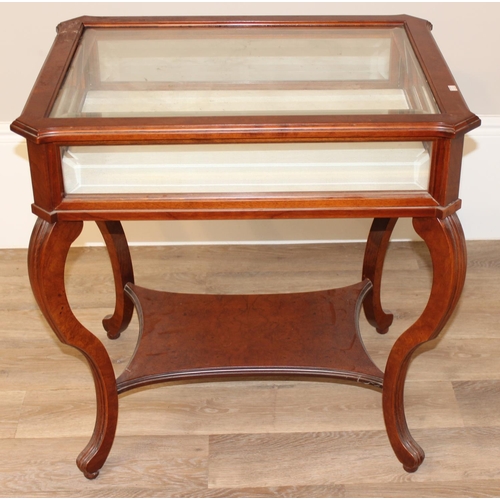 133 - An antique style mahogany bijouterie table with bevelled glass panels and cabriole shaped legs. appr... 