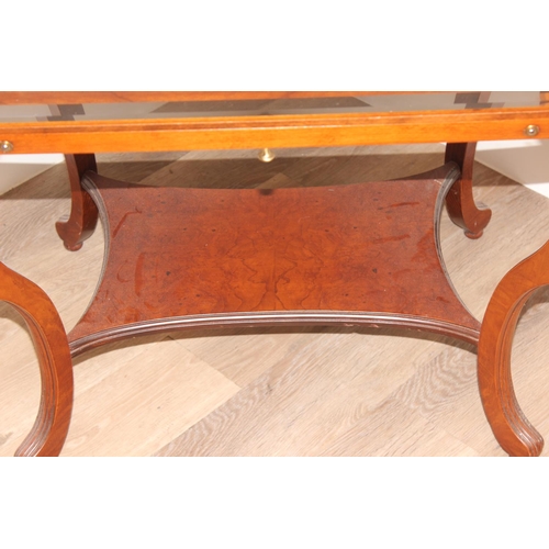 133 - An antique style mahogany bijouterie table with bevelled glass panels and cabriole shaped legs. appr... 