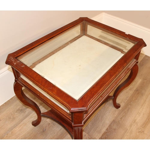 133 - An antique style mahogany bijouterie table with bevelled glass panels and cabriole shaped legs. appr... 