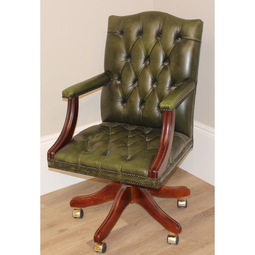 135 - A green Chesterfield leather button backed office or captains' swivel chair, approx 59cm wide x 68cm... 