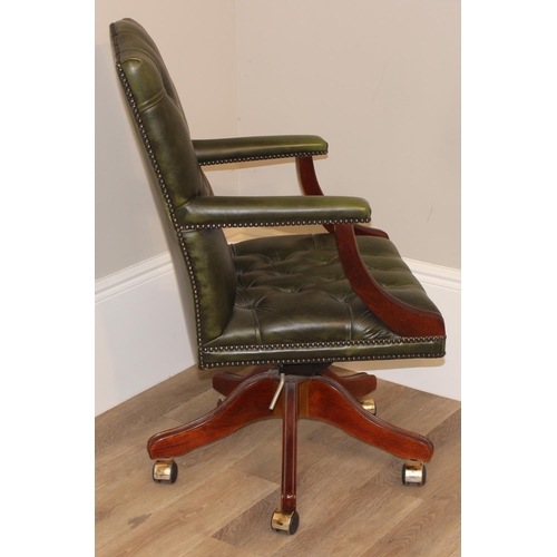 135 - A green Chesterfield leather button backed office or captains' swivel chair, approx 59cm wide x 68cm... 