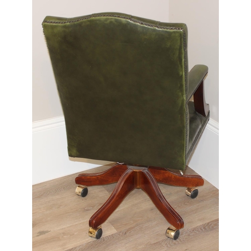 135 - A green Chesterfield leather button backed office or captains' swivel chair, approx 59cm wide x 68cm... 