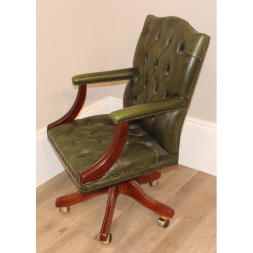 135 - A green Chesterfield leather button backed office or captains' swivel chair, approx 59cm wide x 68cm... 