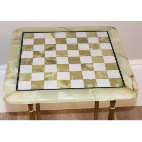 137 - A vintage onyx or marble chess board on gilt metal table base, approx 46cm wide x 46cm deep x 68cm t... 