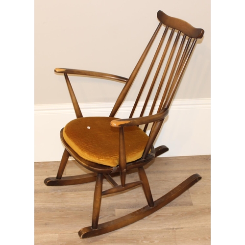 140 - A vintage Ercol rocking chair with original upholstered seat, with original blue & gold label, appro... 