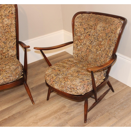 141 - 2 vintage Ercol armchairs with patterned upholstery and stick backs, the larger approx 73cm wide x 8... 