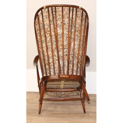 141 - 2 vintage Ercol armchairs with patterned upholstery and stick backs, the larger approx 73cm wide x 8... 