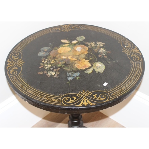 143 - An antique black painted tilt topped table with gilt painted border and central painted flowers with... 