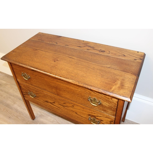 147 - A small vintage oak 2 drawer chest of drawers on square legs, approx 91cm wide x 45cm deep x 78cm ta... 