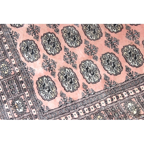 200 - A vintage Afghan style rug of salmon ground, approx 190 x 127cm