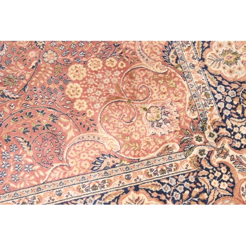 202 - A large vintage Dwalabad decorative rug of red and blue ground, approx 300 x 200cm