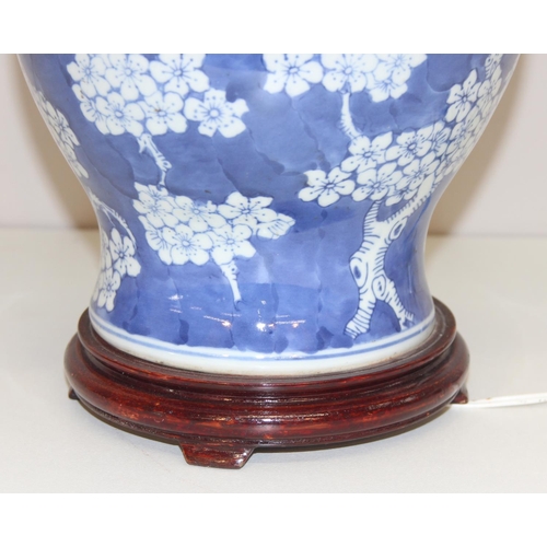 253 - Vintage blue and white Chinese style ginger jar shaped lamp with cherry blossom design decoration on... 