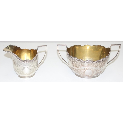 1030 - 5 pieces of antique silver plate to include a sugar bowl and cream jug, sugar castor and wick trimme... 