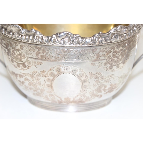 1030 - 5 pieces of antique silver plate to include a sugar bowl and cream jug, sugar castor and wick trimme... 