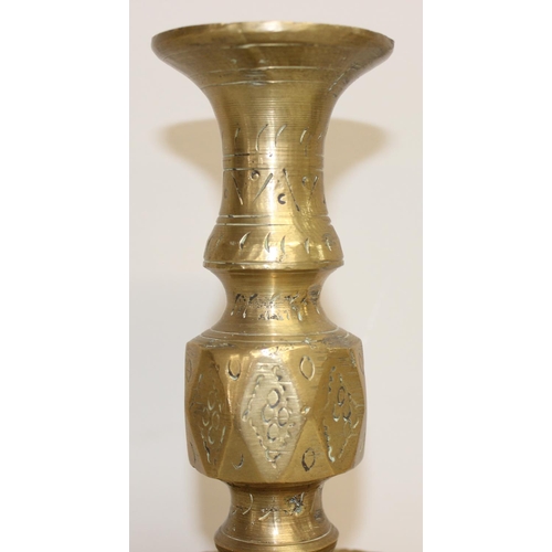 1543 - A pair of 16th century style brass candlesticks of large size with engraved design, approx 27cm tall