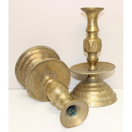 1543 - A pair of 16th century style brass candlesticks of large size with engraved design, approx 27cm tall