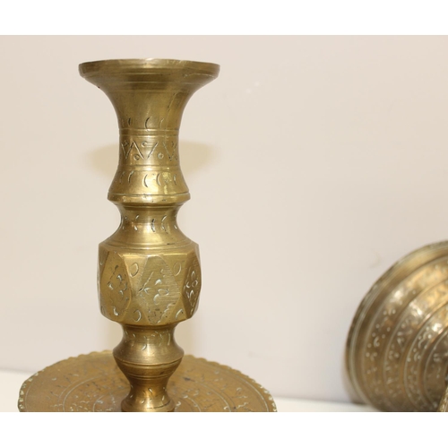 1543 - A pair of 16th century style brass candlesticks of large size with engraved design, approx 27cm tall