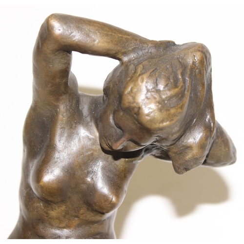 1562 - A 20th century bronzed metal figure of a female nude on black marble base, seemingly unmarked, appro... 