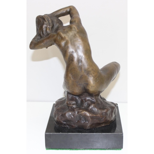 1562 - A 20th century bronzed metal figure of a female nude on black marble base, seemingly unmarked, appro... 