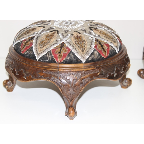 168 - A pair of Victorian footstools with beadworks tops and carved wooden bases, each approx 29cm in diam... 