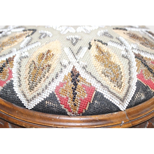 168 - A pair of Victorian footstools with beadworks tops and carved wooden bases, each approx 29cm in diam... 