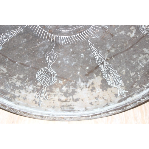 1744 - A large patinated copper Benares table top or tray with engraved decoration, approx 72cm in diameter