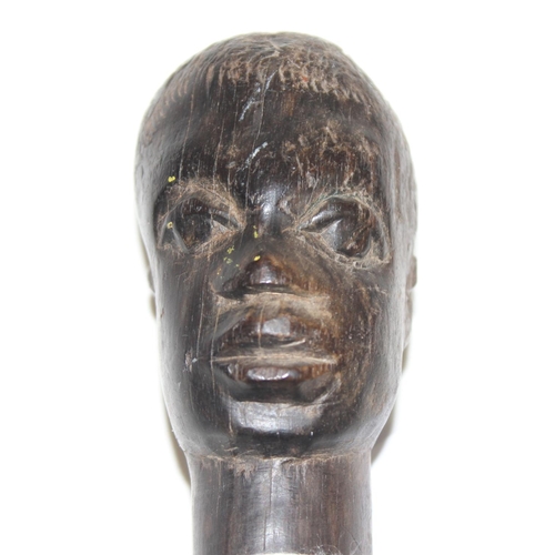 1747 - An antique African carved wooden stick with head pommel and twisted shaft, likely 19th century, appr... 