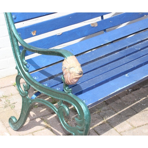 352 - Cast iron and teak painted garden bench with lion head decorated bench ends approx 127cm W