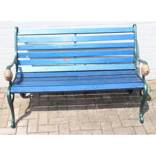 352 - Cast iron and teak painted garden bench with lion head decorated bench ends approx 127cm W