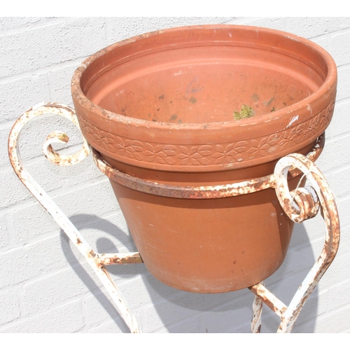 354 - A vintage twisted wrought iron garden pot stand with terracotta pot, approx 100cm tall