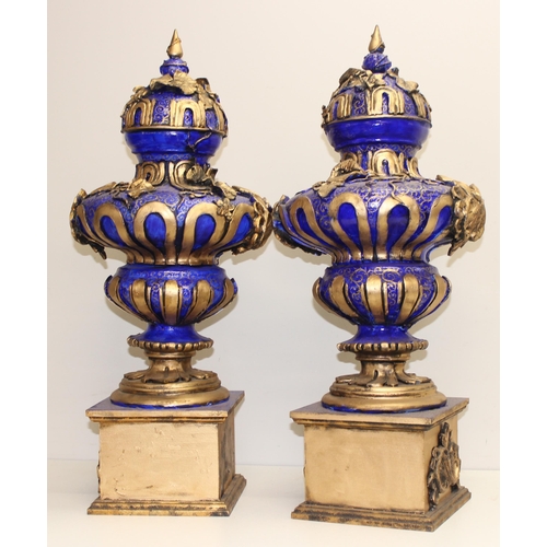 1784 - A pair of gold and blue relief decorated Regency style urn displays, each approx 70cm tall