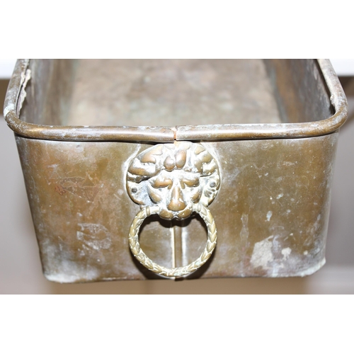 1794 - A large vintage brass planter of oblong form with lion mask handles to end, approx 92cm wide x 21cm ... 