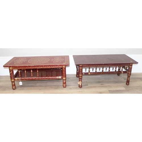 114 - A near pair of Indian style red and gold painted low tables, each approx 92cm x 46cm x 38cm tall