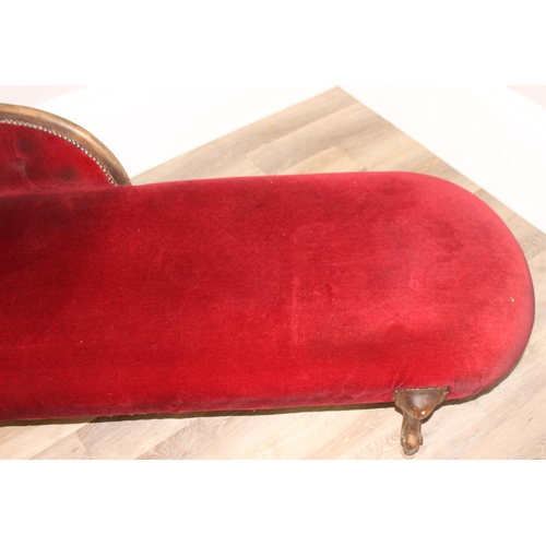 126 - A vintage Chaises Longue with distressed carved wooden frame and burgundy button back upholstery, ap... 