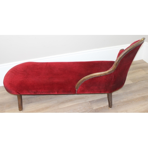 126 - A vintage Chaises Longue with distressed carved wooden frame and burgundy button back upholstery, ap... 