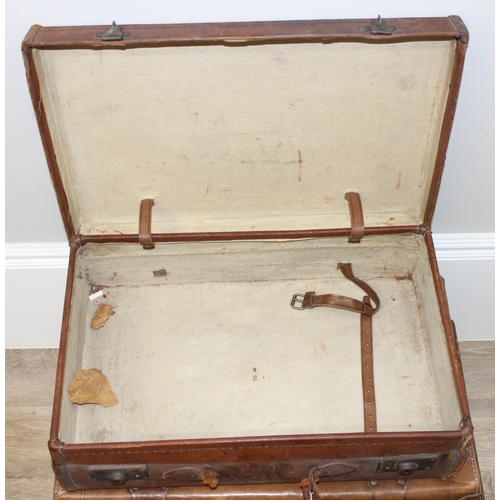 323 - 5 assorted vintage suitcases, 2 good quality leather examples and some with labels, the largest appr... 