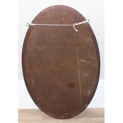 450S - Large oak framed oval mirror with decorative wooden edge, approx 107cm x 65cm