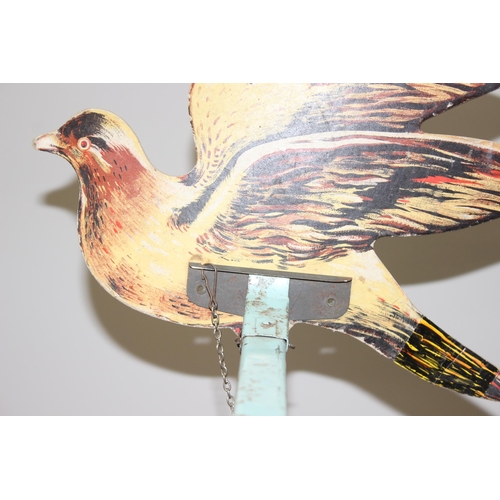 612 - An early 20th century French pigeon target game, three cut out pigeons are fixed to extended arms an... 