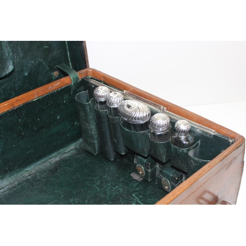 1085 - A Victorian Gentleman's leather suitcase with silver-topped vanity bottles, the case made by S. Fish... 