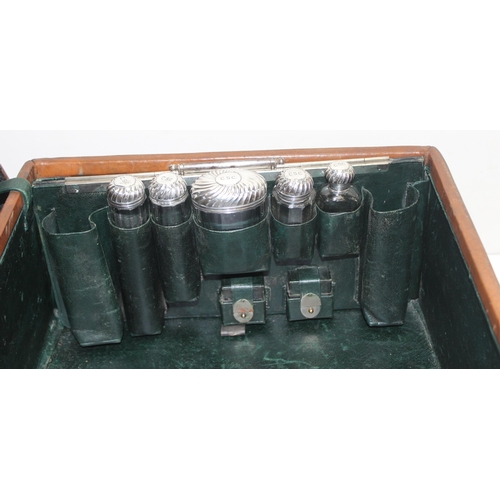 1085 - A Victorian Gentleman's leather suitcase with silver-topped vanity bottles, the case made by S. Fish... 