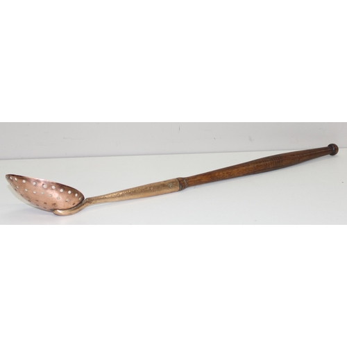 1800 - An antique heavy-gauge long turned-handled copper and brass straining spoon with half-pierced bowl, ... 