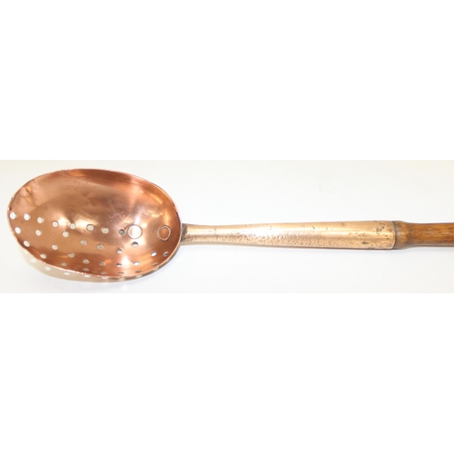 1800 - An antique heavy-gauge long turned-handled copper and brass straining spoon with half-pierced bowl, ... 