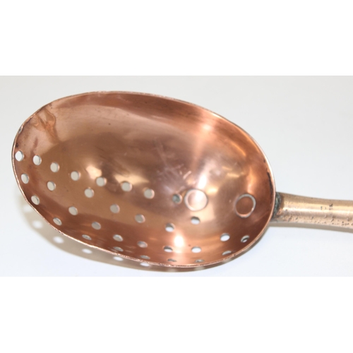 1800 - An antique heavy-gauge long turned-handled copper and brass straining spoon with half-pierced bowl, ... 