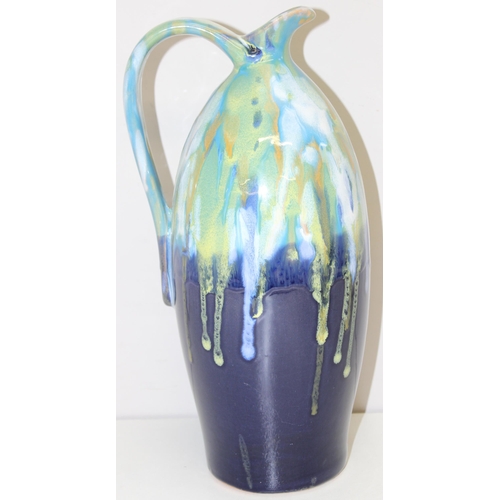 1802 - A large studio pottery Faience drip-gazed jug in blues and greens, unmarked, approx 33cm