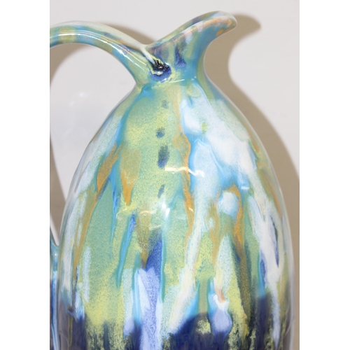 1802 - A large studio pottery Faience drip-gazed jug in blues and greens, unmarked, approx 33cm