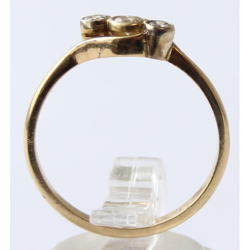 1103 - A vintage 18ct gold diamond trilogy ring with crossover setting, marked 18ct and XRF confirmed, the ... 