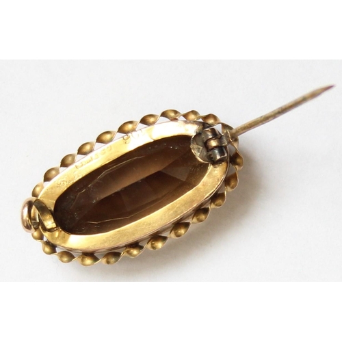 1132 - An antique 9ct gold mounted brooch set with smoky quartz coloured cut stone, approx 28mm wide, appro... 