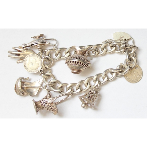 1138 - A vintage silver charm bracelet with charms to inc Viking Longboat, Aladdin's Lamp etc, approx 69.22... 